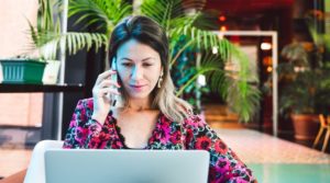 woman talking on phone in virtual therapy session