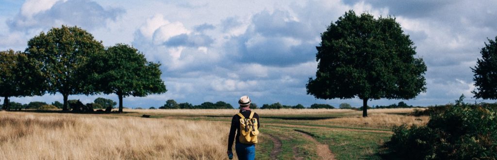 man walking in field