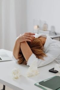 woman with head on desk